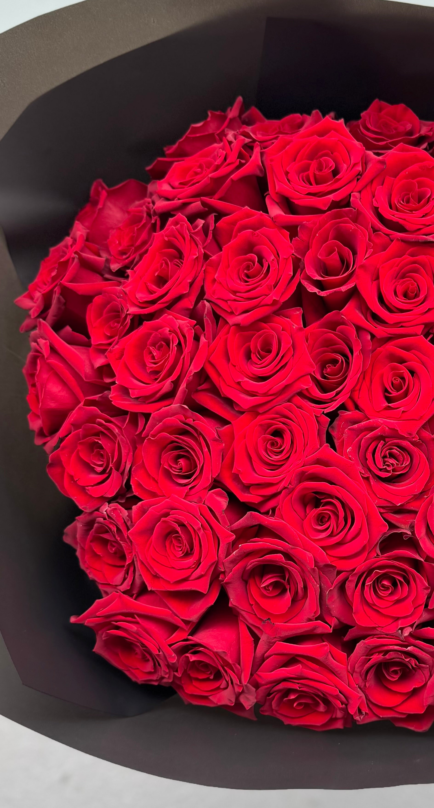 Ready. 20 red roses. Black wrapping.
